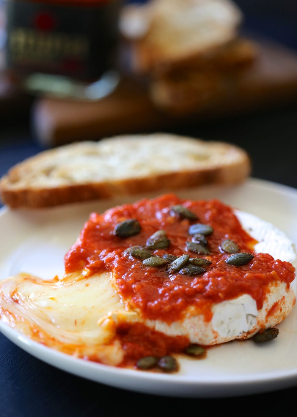 Harissa & moroccan spiced pepitas on baked brie