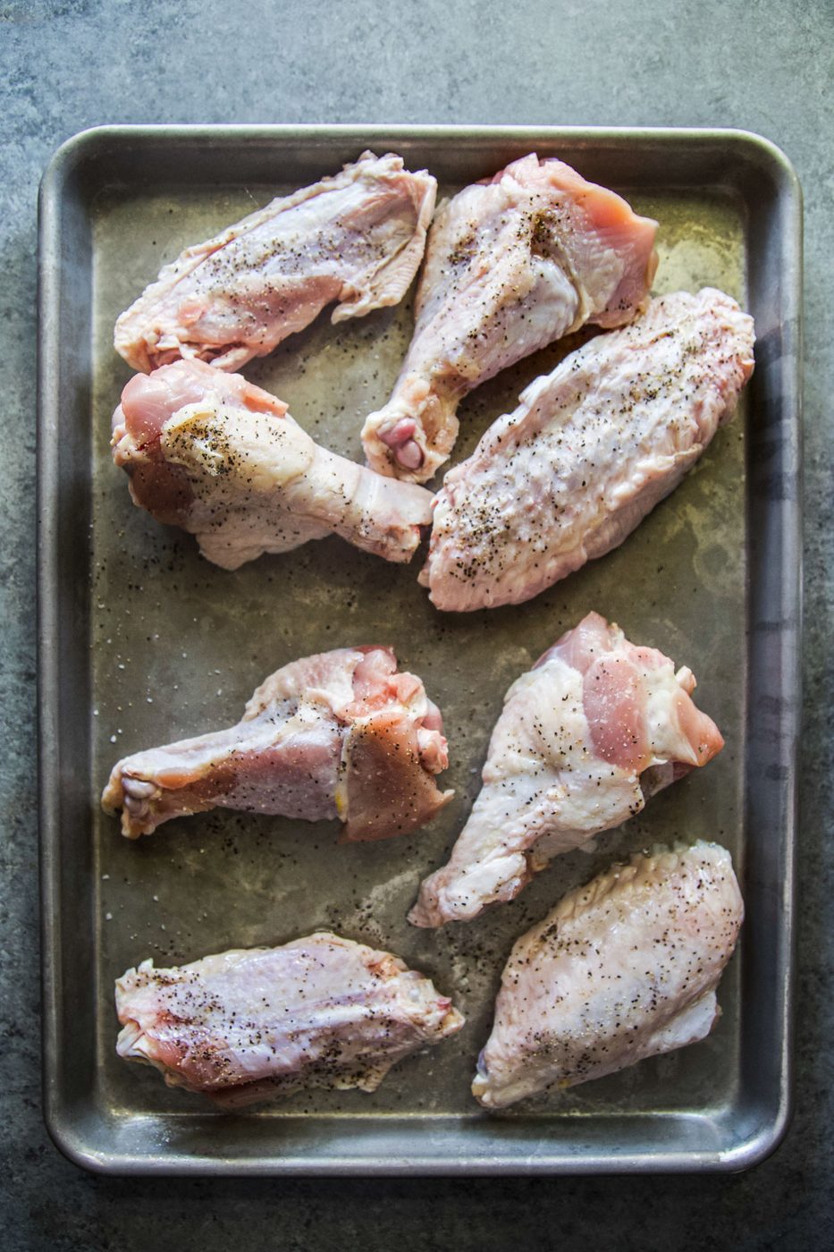 uncooked turkey wings on a sheet pan