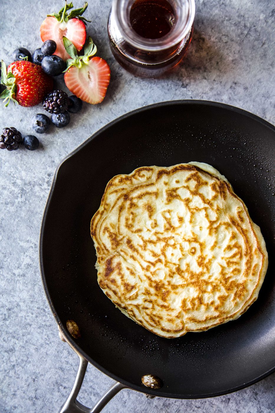 pancake in a skillet Simple Souffle Pancakes with Mixed Berries