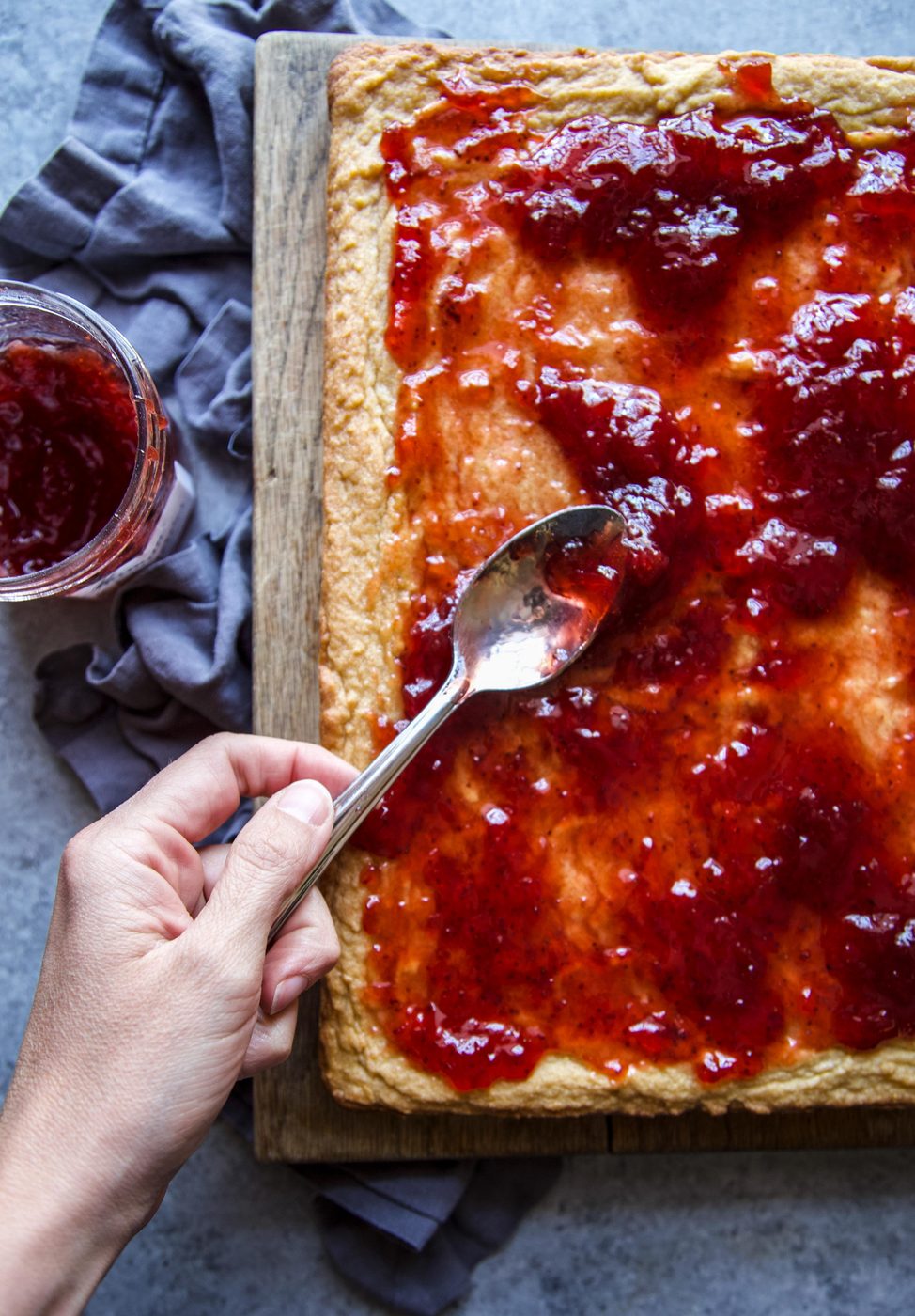 strawberry preserves being placed on the bars