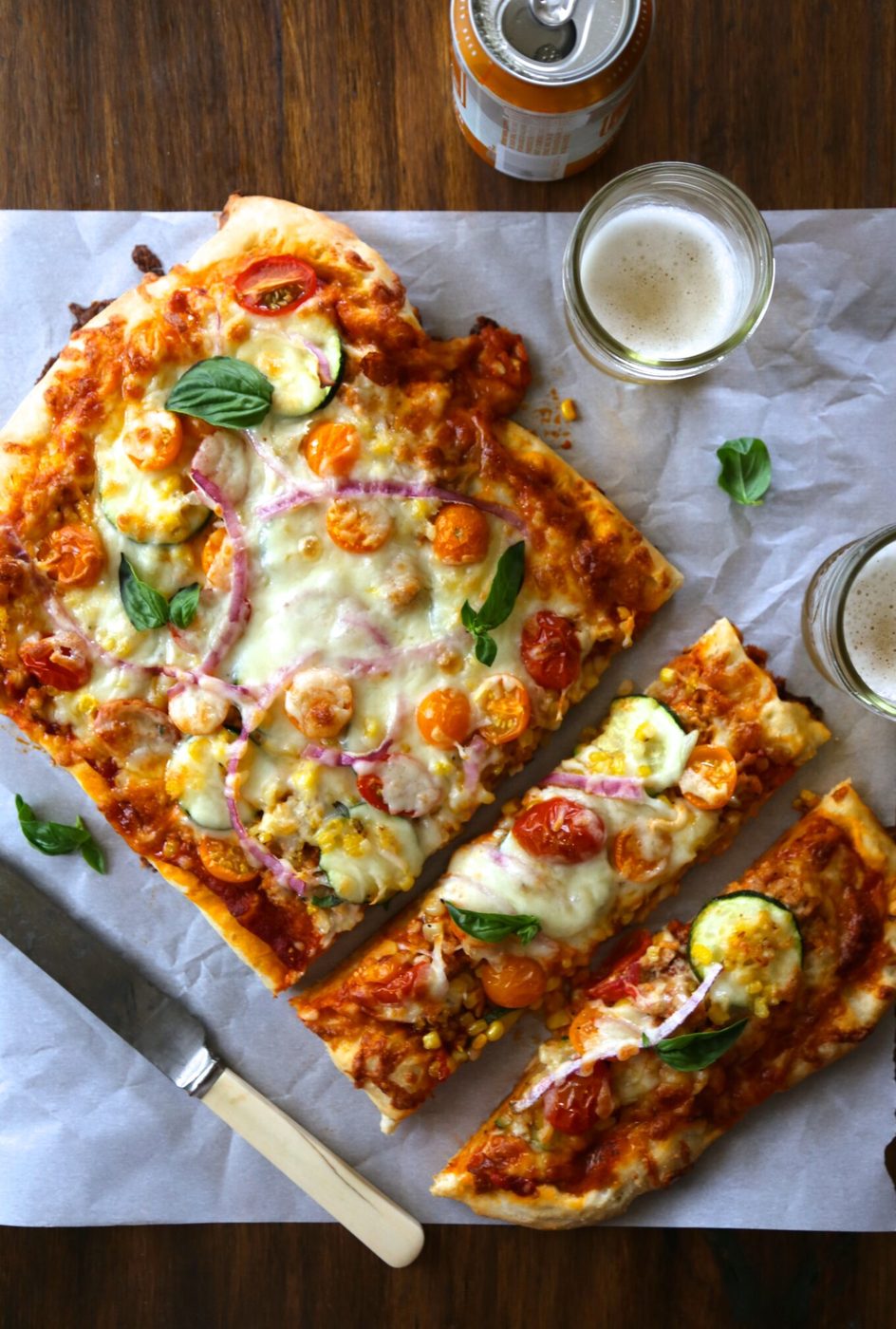 Farmer’s market thin crust pizza, finished with burrata & chicken sausage