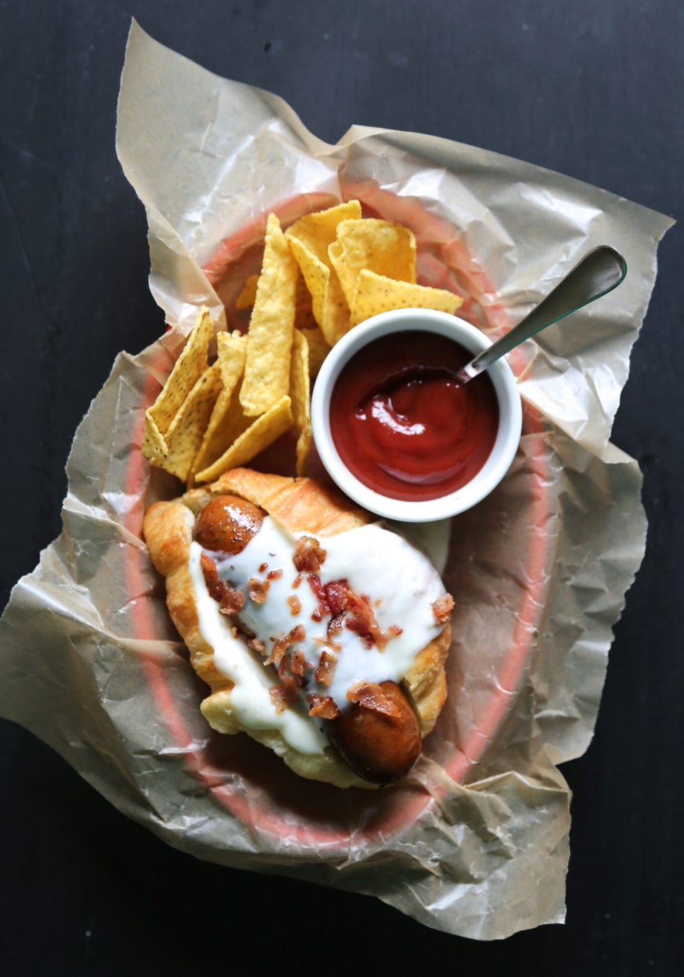 Crispy bacon on french croissant hot dogs