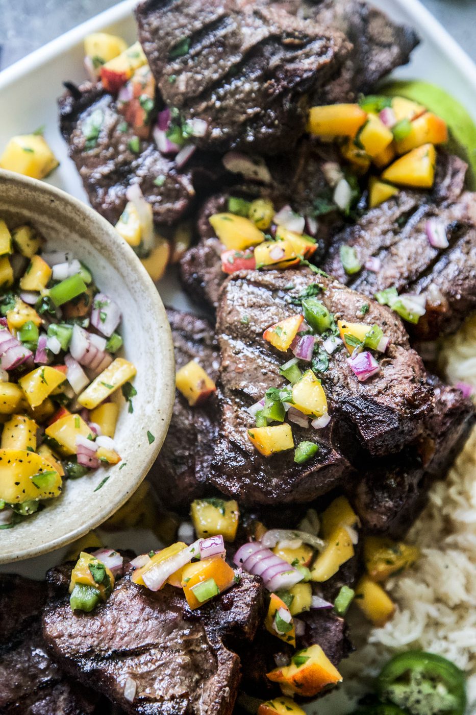 Grilled Jerk American Lamb Loin Chops with Peach Salsa Use American Lamb/h2pWe used American Lamb in this recipe. Their lean, nutrient-rich loin chop is ideal for making a lot of dishes, but they are truly magnificent when used in this late-summer infused meal. Aside from the fact that they are one of the most savory types of protein out there, they are also packed with an array of essential nutrients such as zinc, selenium, and vitamins B6 and B12. /ppPlus- did you know that a 3-ounce serving of American lamb loin chop has approximately 140 calories and 22.5 grams of protein? It’s the reliable protein to mix up your weeknight dinner routine whether grilling, pan frying, or roasting. /pfigureimg src=