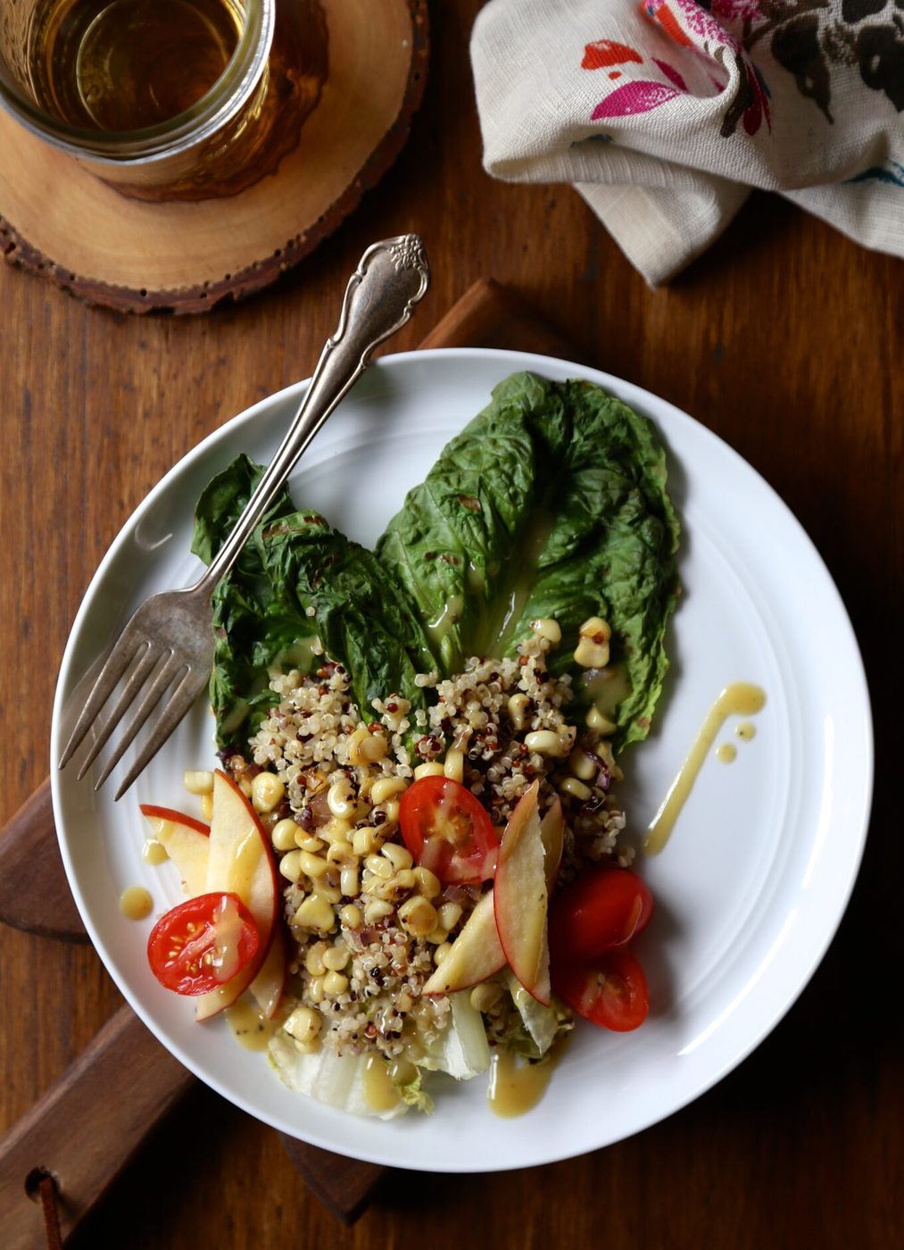 Grilled romaine salad, finished with quinoa, apples, corn, & dijon vinaigrette
