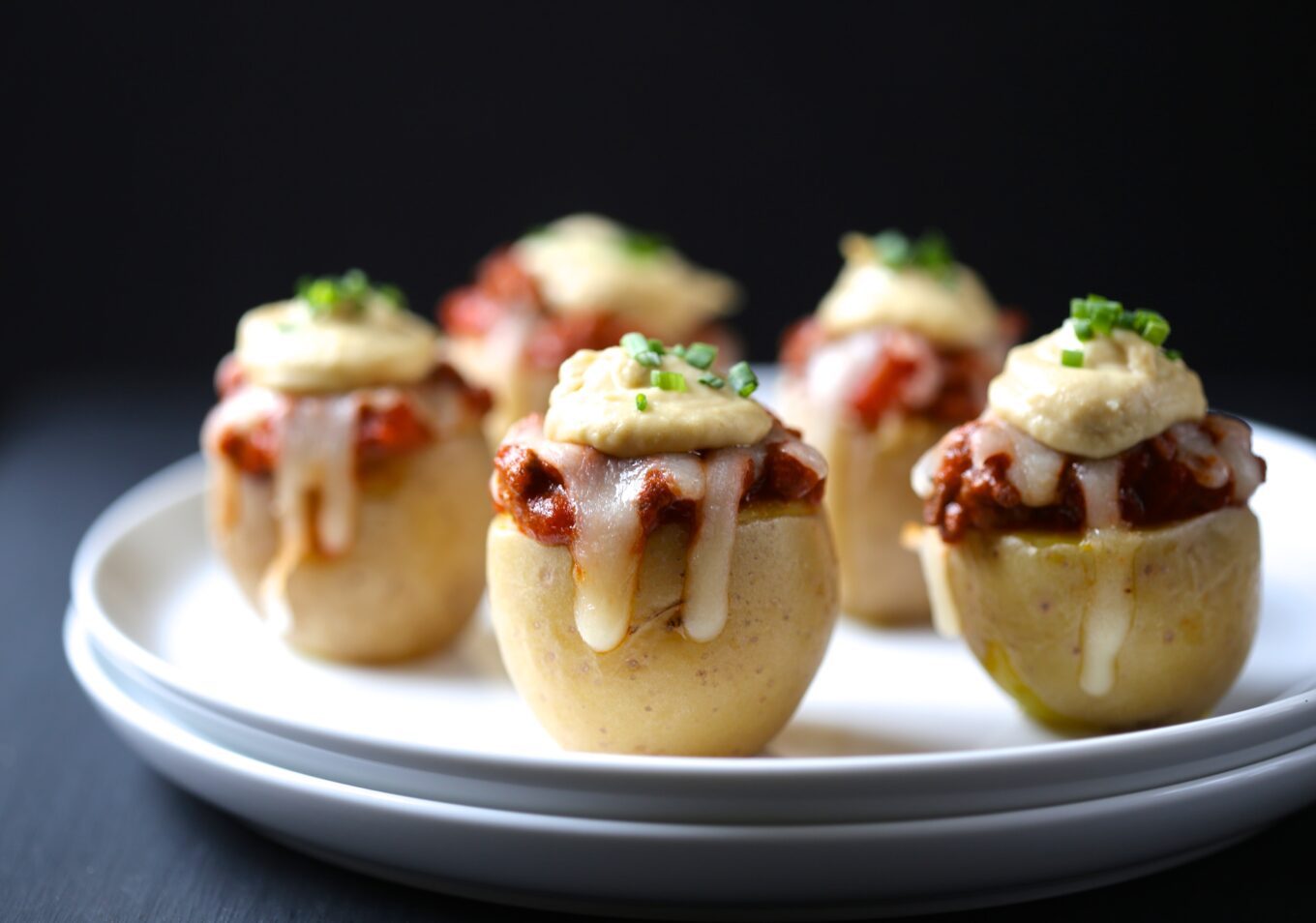 Hamburger pizza stuffed mini potatoes, finished with ranch hummus