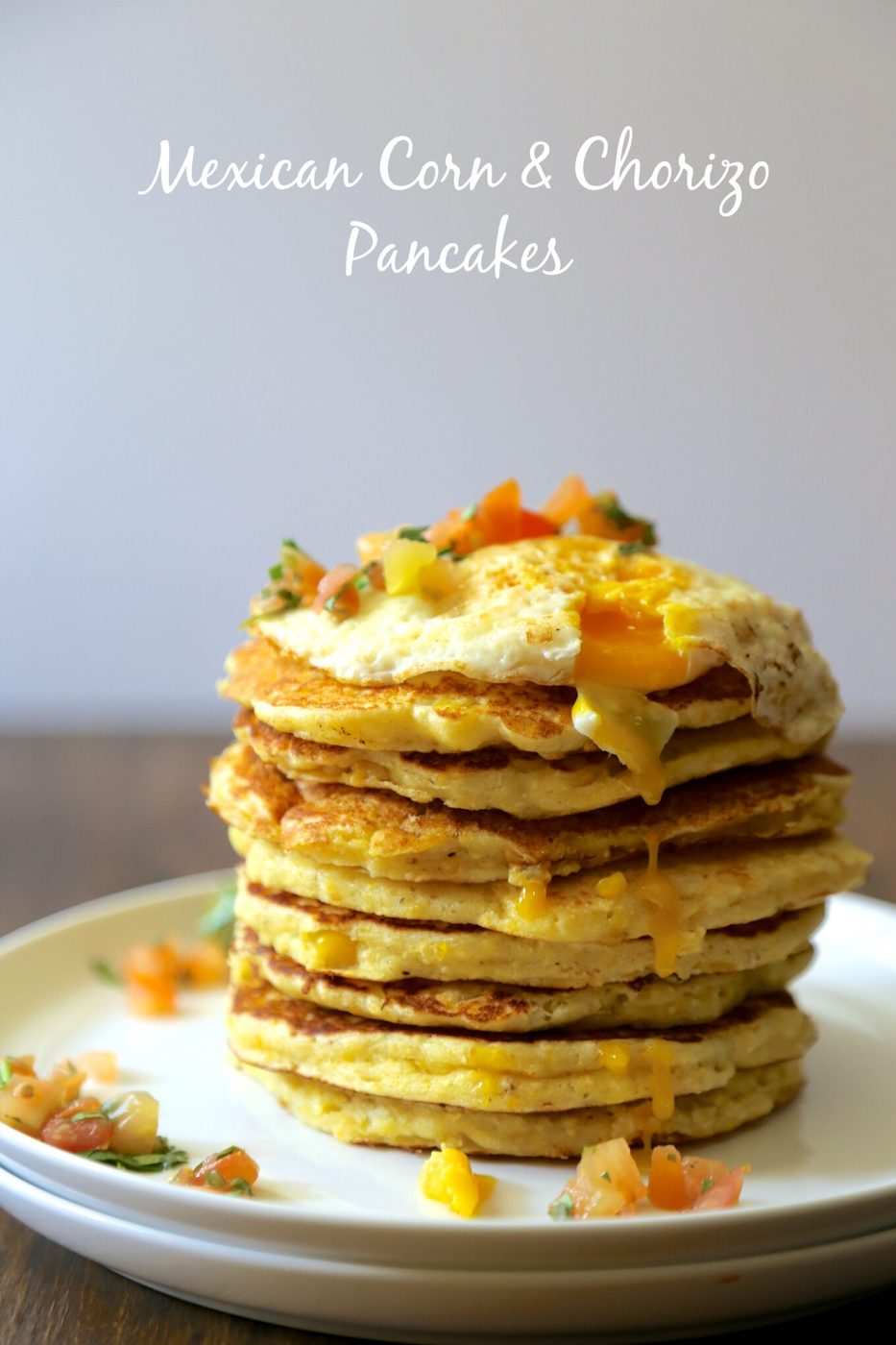 Fried egg & heirloom tomato salsa on mexican corn & chorizo pancakes