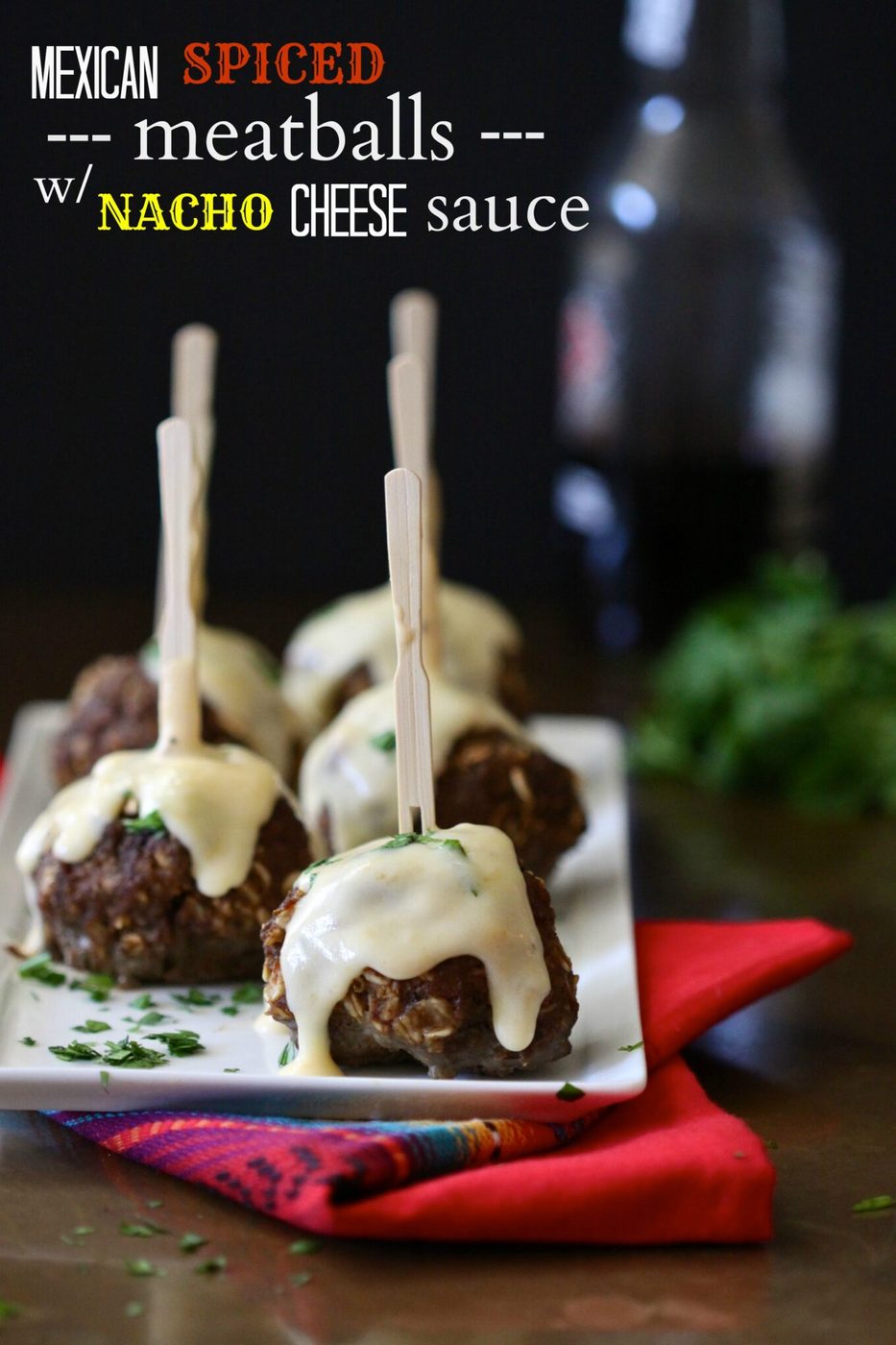 Kitchen-made nacho cheese sauce on mexican spiced meatballs