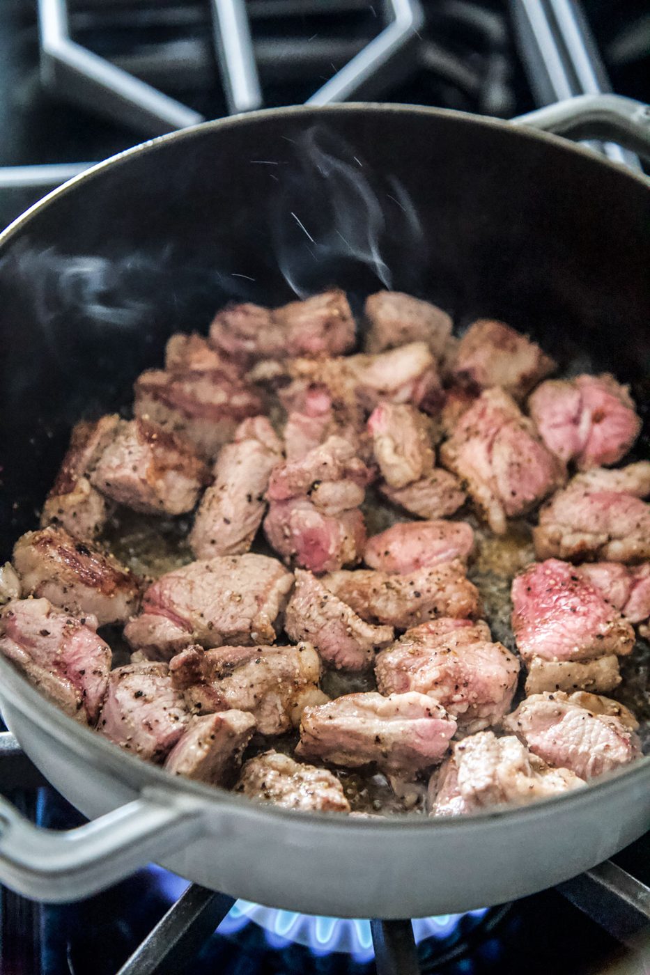 lamb shoulder simmering in a pot