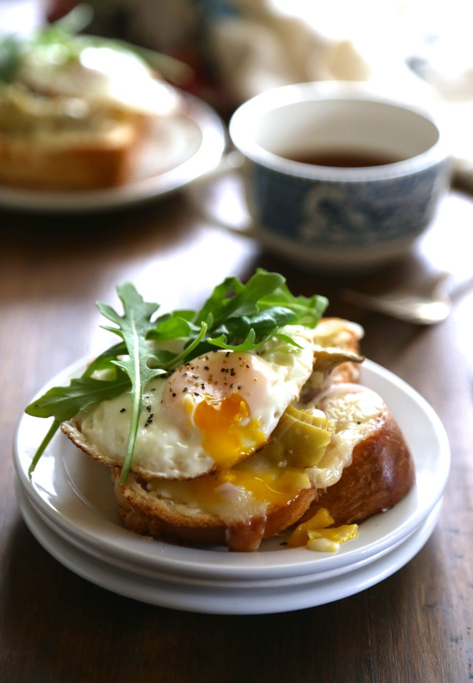 Open-faced artichoke & arugula sandwiches, finished with sunny-side up egg