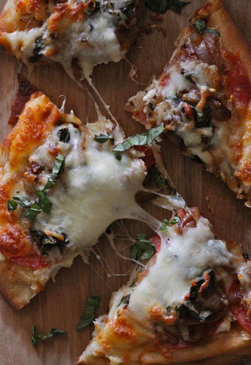 Balsamic caramelized onions on pepperoni and ricotta naan pizza