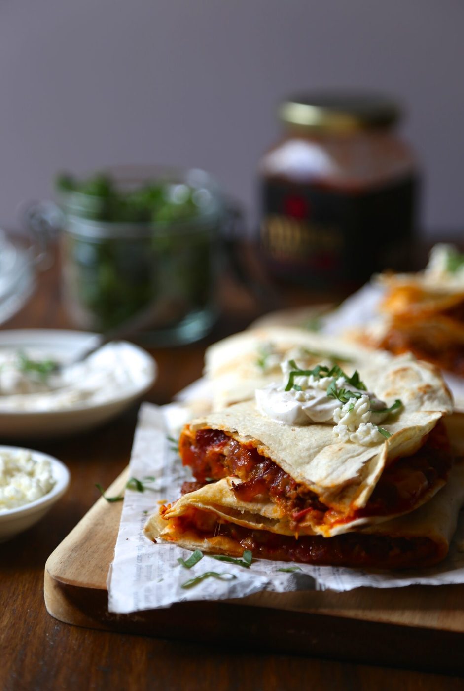 Spicy harissa quesadilla, finished with lamb, caramelized onions, and cojita-feta cheese