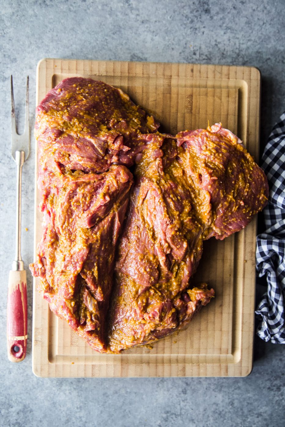 marinated butterflied leg of lamb on a cutting board