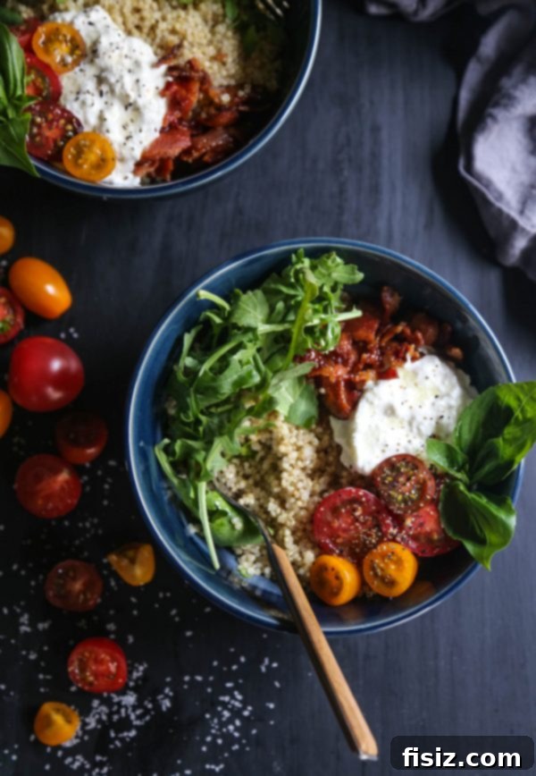 Caprese BLT Bowl featuring fresh burrata, ripe tomatoes, crispy bacon, and arugula over quinoa
