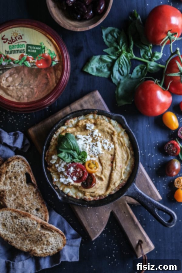 Creamy Four Cheese Greek Pizza Dip with Tuscan Herb Hummus 5 Four Cheese Greek Pizza Dip in a skillet, ready to serve
