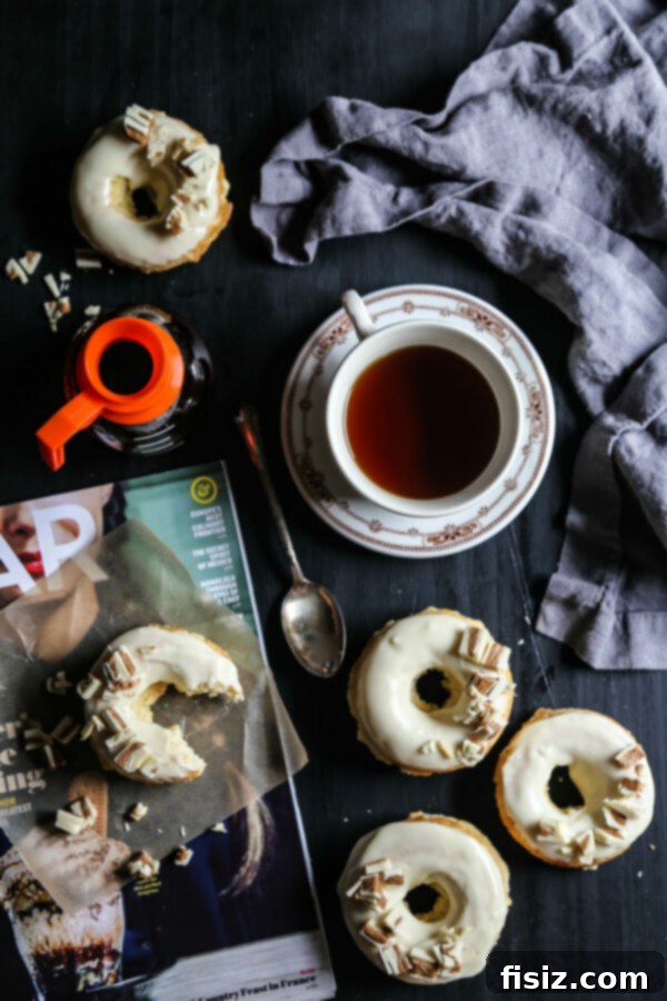 Baked White Chocolate Doughnuts with Peanut Butter Crumble 2 Delicious White Chocolate Baked Doughnuts with White Chocolate Peanut Butter Crumbles on a serving tray