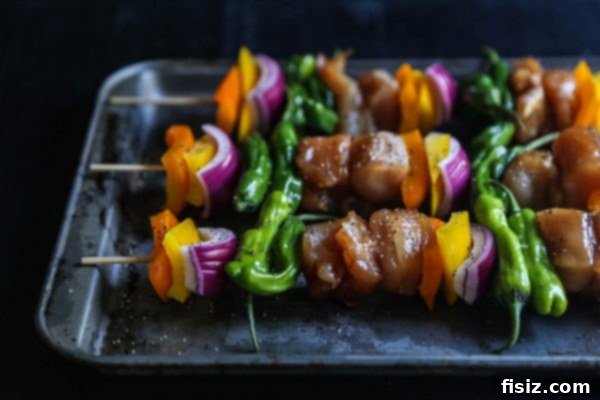 Teriyaki Glazed Chicken and Shishito Skewers 4 Assembling chicken and vegetable skewers with care