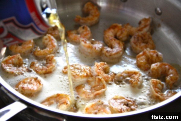 Beer Week: Pale Ale Shrimp Po' Boy 4 Hands holding a can of craft beer, suggesting a thoughtful selection process