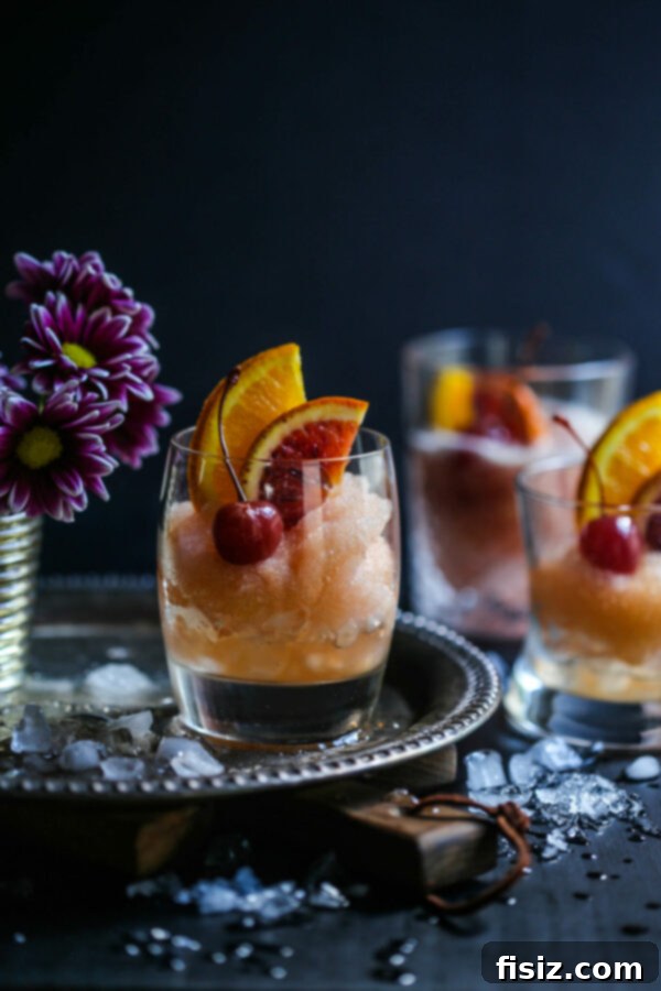 Frozen Old Fashioned 2 Refreshing Old Fashioned Cocktail Slushie with Bourbon, Bitters, and Orange Garnish