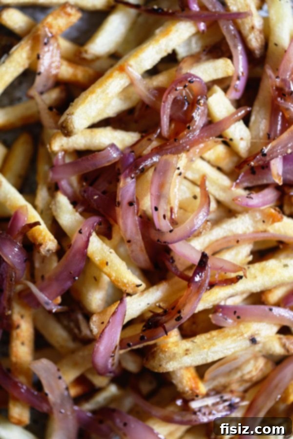Aromatic Ginger Curry Poutine 4 Pouring rich ginger curry gravy over golden homemade french fries