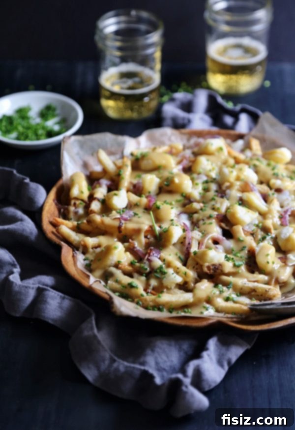 Aromatic Ginger Curry Poutine 5 An overhead view of Ginger Curry Poutine topped with fresh chives