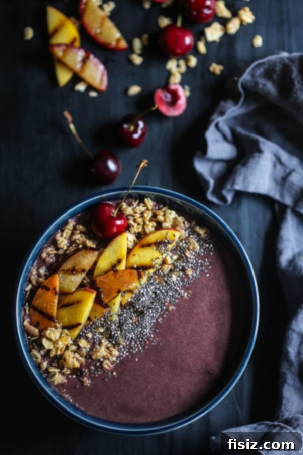 Closeup of Grilled Stone Fruit Acai Bowl with a spoon