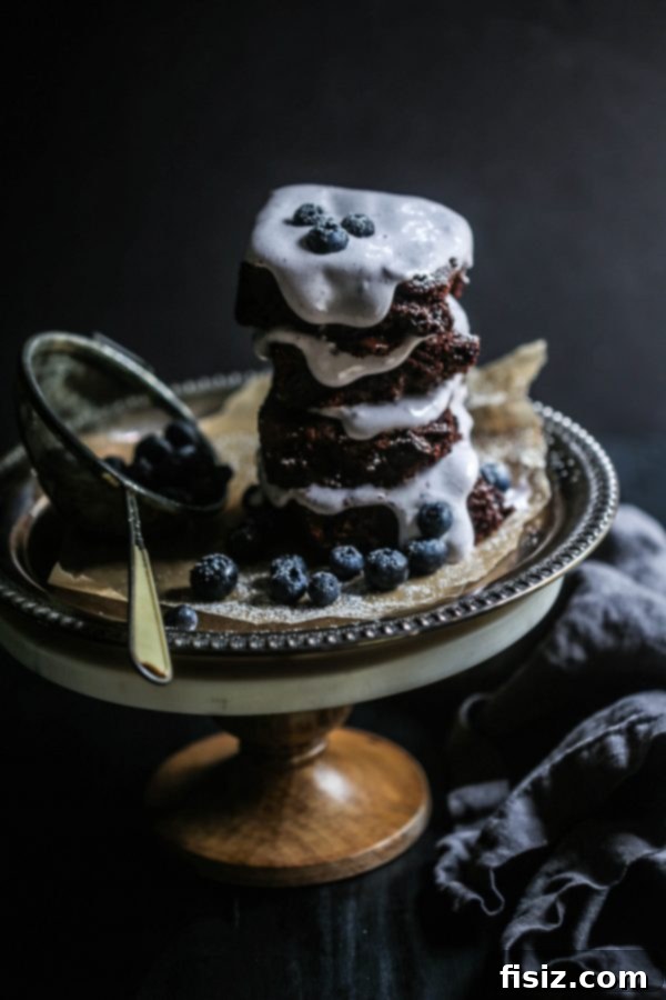 Decadent Dark Chocolate Brownies with Pillowy Blueberry Marshmallow Frosting 8 Collection of Dark Chocolate Brownies with Blueberry Marshmallow Frosting on a cooling rack