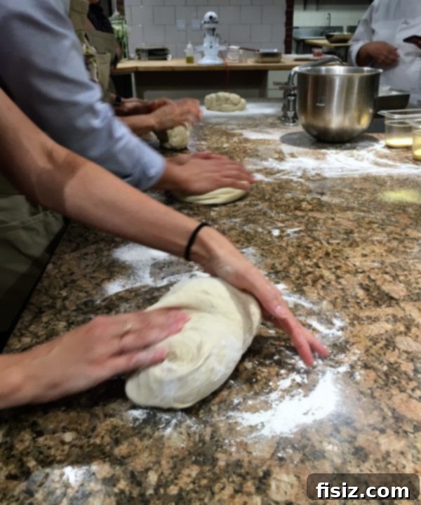 Smoked Mozzarella, Salami and Hominy Pizza 4 Close-up of freshly made pizza dough being prepared for cooking