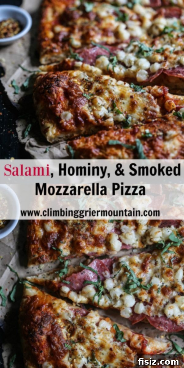 Smoked Mozzarella, Salami and Hominy Pizza 10 Top-down shot of a freshly baked Salami, Hominy, & Smoked Mozzarella Pizza with basil garnish