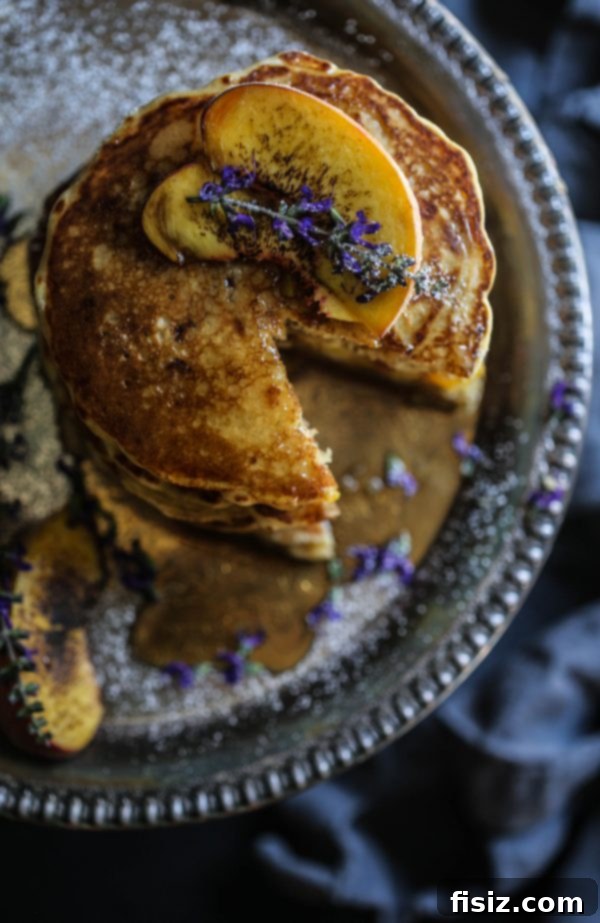 Decadent Peach and Bacon Pancakes with Lavender Butter Syrup 6 Golden-brown Peach and Bacon Pancakes topped with a generous drizzle of lavender butter syrup.