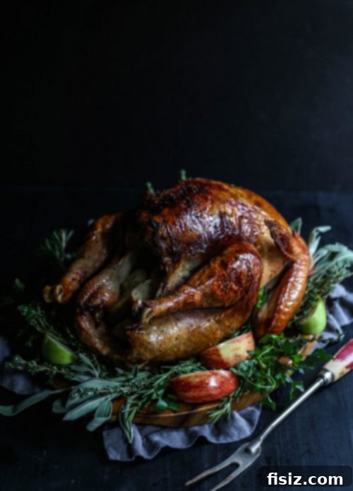 Golden Apple Cider Turkey with Aromatic Herb Butter 6 A close-up of sliced, juicy Apple Cider-Glazed Roasted Turkey on a cutting board