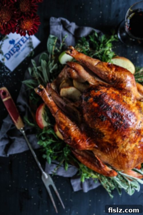 Golden Apple Cider Turkey with Aromatic Herb Butter 7 A festive holiday table setting with the Apple Cider-Glazed Roasted Turkey as the centerpiece