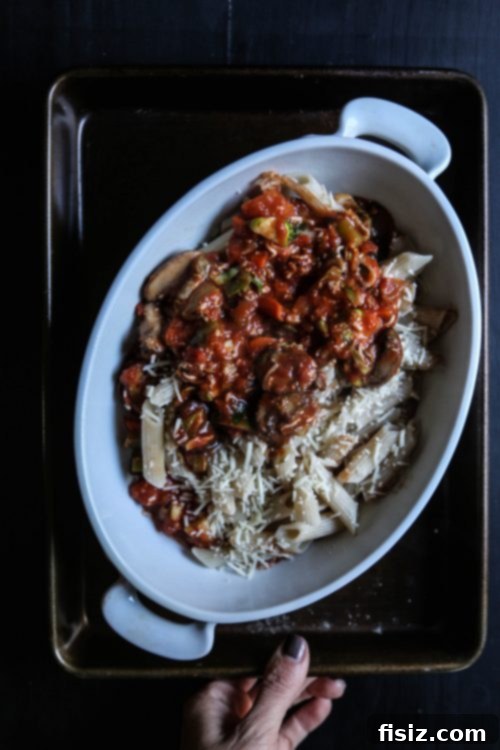Overhead view of a prepared Butternut Squash Bolognese Pasta Bake with creamy brie topping
