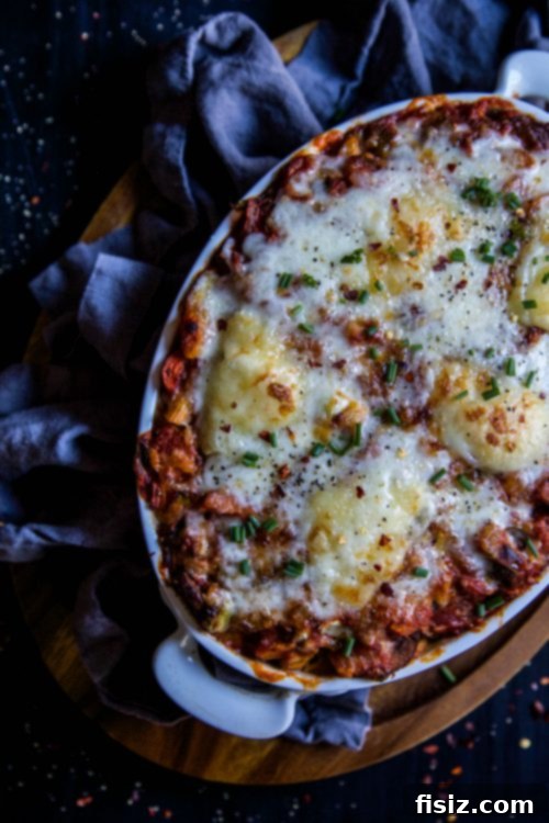 Butternut Squash Bolognese Pasta Bake with Melted Brie, ready for serving at a festive meal