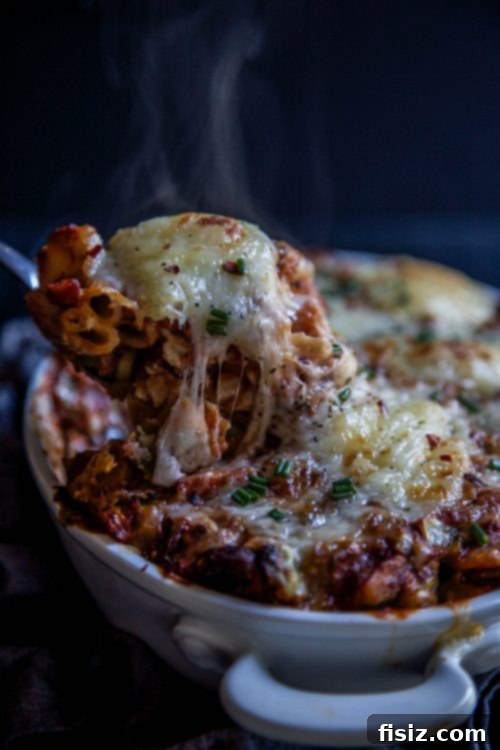 Butternut Squash Bolognese Pasta Bake topped with fresh basil, ready to be enjoyed by family and friends