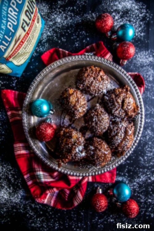 Rich Chocolate Mocha Gingerbread Fritters 7 Hand reaching for a gingerbread fritter with chocolate mocha glaze