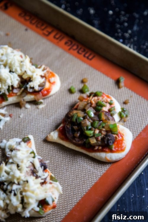 Supreme Love Bites 4 Mini Heart-Shaped Supreme Pizzas arranged on a baking sheet