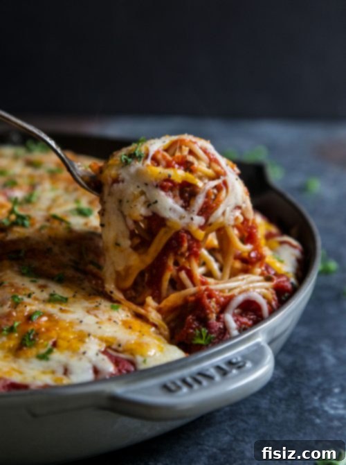 Ultimate Million Dollar Cheeseburger Spaghetti 6 A freshly baked casserole of Million Dollar Cheeseburger Spaghetti, bubbling with cheese and ready to be served, still in the baking dish.