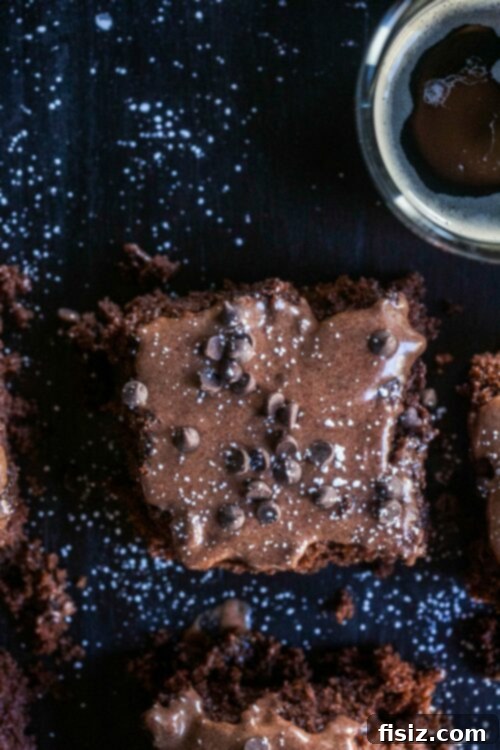 Rich Chocolate Treat with Stout-Spiked Ganache 5 Smooth and glossy Guinness Ganache Frosting being poured over a freshly baked cake