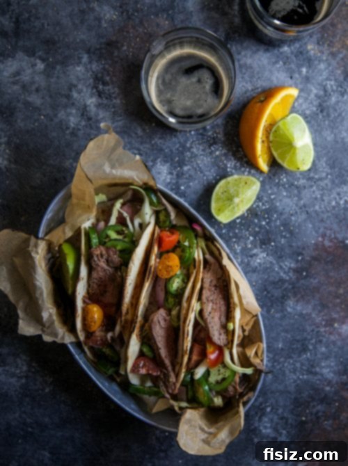 Cuban Mojo Steak Tacos 5 Sliced citrus-marinated steak ready for tacos, served on a wooden board