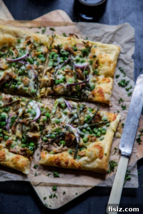 Golden Turmeric Chicken Pizza with Asparagus and Sweet Peas 4 Close-up of Turmeric Chicken Pizza on puff pastry before baking