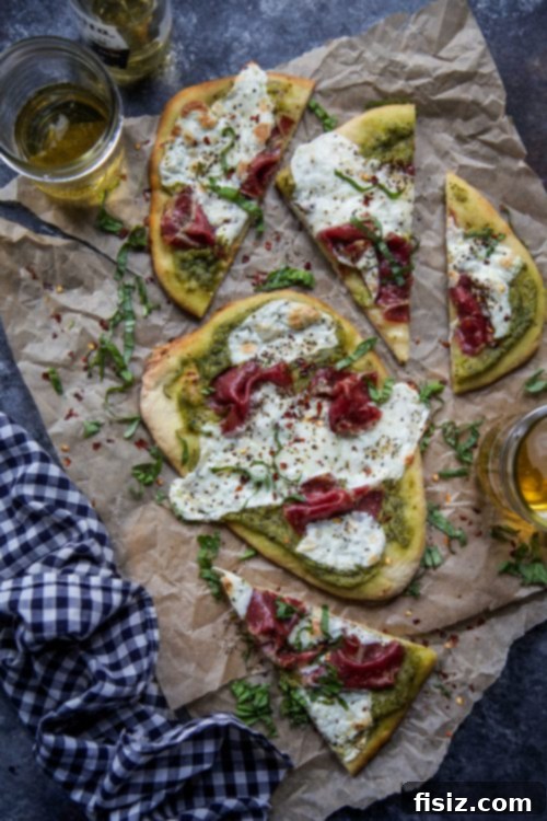 Creamy Avocado Pesto Flatbread with Soppressata and Melted Mozzarella 2 Delicious Mozzarella and Soppressata Flatbread with Avocado Pesto on a rustic wooden board