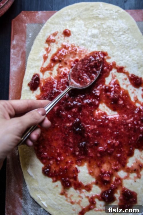 Unbaked strawberry cinnamon rolls in a baking dish