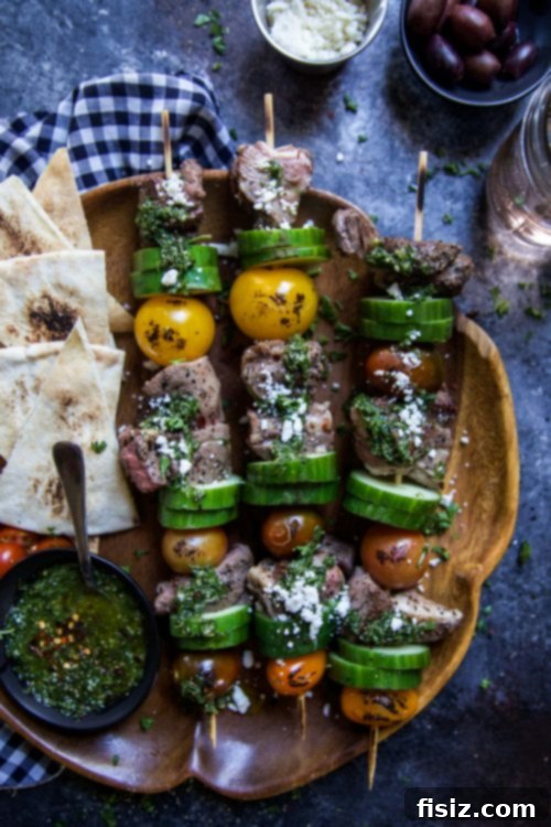 Succulent Lamb Kebabs with Zesty Anatolian Herb Relish 2 Grilled Lamb Skewers with Turkish Chimichurri ready to be served