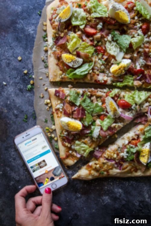 Serving slice of Summer Cobb Salad Pizza, ready to enjoy