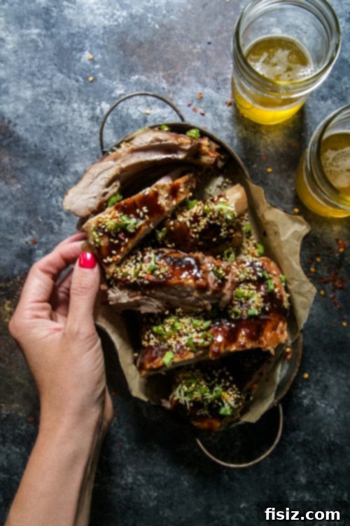 Plated Slow Cooker Asian-Style Ribs ready to serve with sesame sprinkle