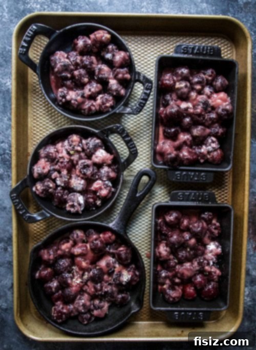 Rustic Cherry Lavender Skillet Pies 4 A basket filled with fresh cherries, a sprig of lavender, and a lemon, hinting at the pie's ingredients.