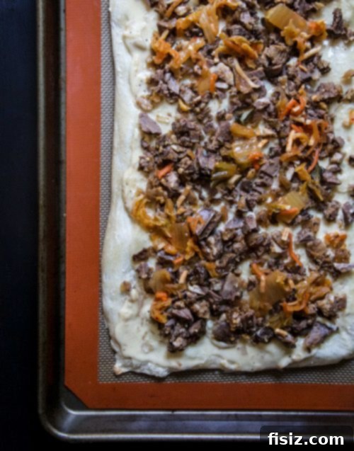 Slow Cooked Sriracha Beef Short Rib Kimchi White Pizza 3 Close-up of Slow Cooker Sriracha Beef Short Rib & Kimchi White Pizza slice