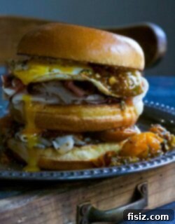 Gourmet Prosciutto Egg Sandwich with Tarragon Tomato 8 Final Prosciutto & Egg Sandwich, garnished and ready to serve