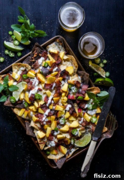 Crispy Bacon and Juicy Peach Sheet Pan Nachos with Zesty Basil-Lime Aioli 5 Serving of Sheet Pan Bacon and Peach Nachos on a plate