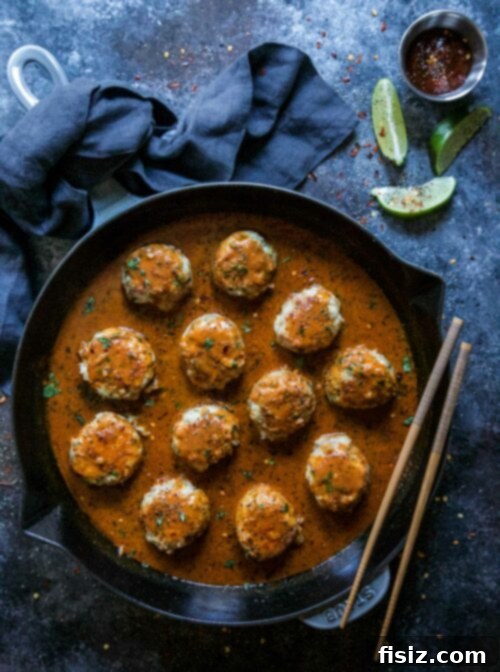Fragrant Thai Red Curry Chicken Meatballs 2 Delicious Thai Red Curry Chicken Meatballs cooking in a cast iron skillet, ready to serve.